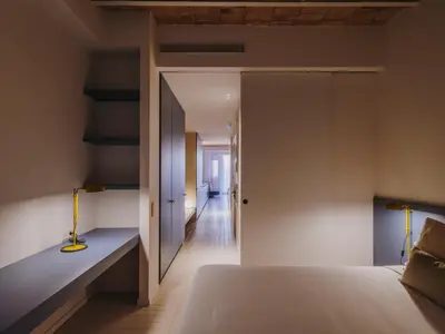 a bedroom with a bed and a hallway at Casa Flor Boutique Mid-term Monthly Rentals in Barcelona