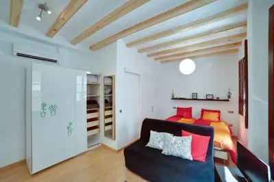 a living room with a couch and a bed at Barceloneta Beach 1 in Barcelona