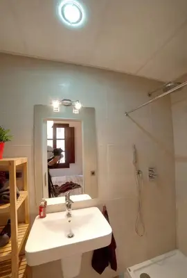 a bathroom with a sink and a shower and a mirror at Barceloneta Beach 1 in Barcelona