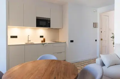 a kitchen with a wooden table in a room at Barcelona - Gracia 3-A in Barcelona