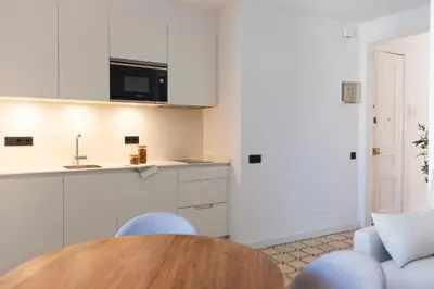 a kitchen with a table and chairs and a sink at Barcelona - Gracia 3-A in Barcelona