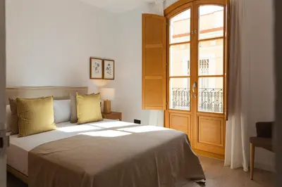 a bedroom with a bed and a large window at Barcelona - Gracia 3-B in Barcelona