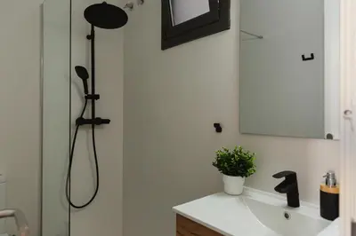 a bathroom with a shower and a sink and a mirror at Barcelona - Gracia 3-B in Barcelona