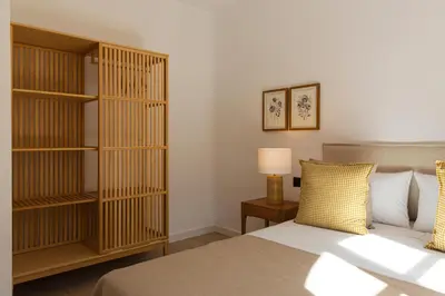 a bedroom with a bed and a book shelf at Barcelona - Gracia 3-B in Barcelona