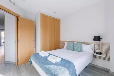 a bedroom with a bed with two towels on it at Weflating Barcelona Sants in Barcelona