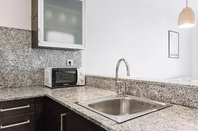 a kitchen counter with a sink and a microwave at Weflating Barcelona Sants in Barcelona