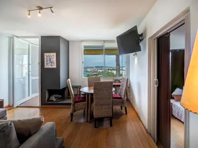 a living room with a table and chairs and a dining room at Balmins Vibes by Hello Homes Sitges in Sitges