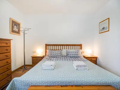 a bedroom with a bed with two towels on it at Balmins Vibes by Hello Homes Sitges in Sitges