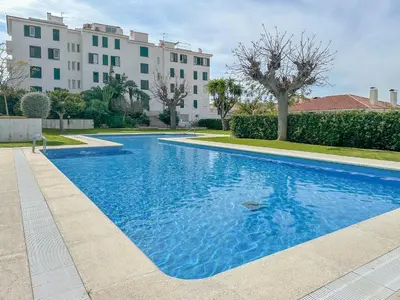 a large blue swimming pool in front of a building at Balmins Vibes by Hello Homes Sitges in Sitges