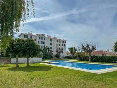 a swimming pool in a yard next to a building at Balmins Vibes by Hello Homes Sitges in Sitges