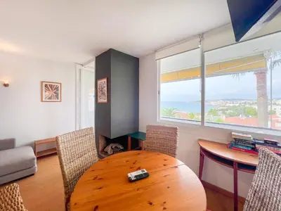 a living room with a wooden table and chairs at Balmins Vibes by Hello Homes Sitges in Sitges