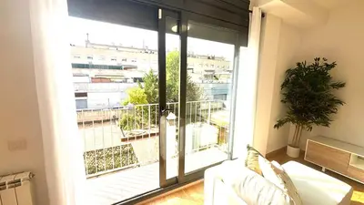 a living room with a large glass door to a balcony at Luminoso apartamento by Prestigi in Terrassa