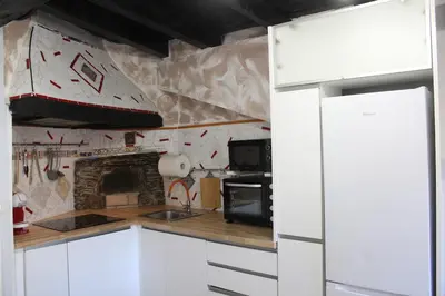 a kitchen with a boat on the wall at 3-Story Gaudi Building with Montserrat Stone in Monistrol