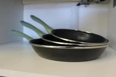 two black pans sitting on a counter with a plant at 3-Story Gaudi Building with Montserrat Stone in Monistrol