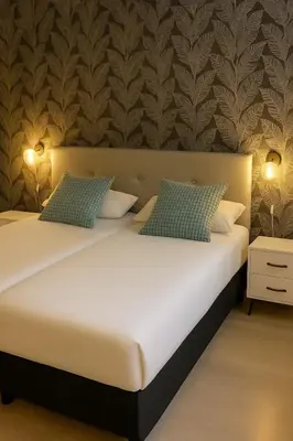 two twin beds in a room with a wall at 3-Story Gaudi Building with Montserrat Stone in Monistrol