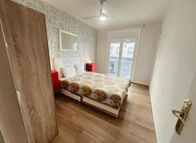 a small bedroom with a bed and a window at 2 bedrooms apartment in Barcelona F1 in Hospitalet de Llobregat