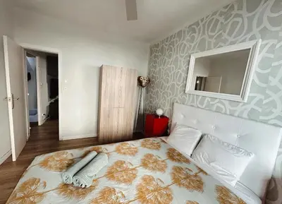 a bedroom with a large bed and a mirror at 2 bedrooms apartment in Barcelona F1 in Hospitalet de Llobregat