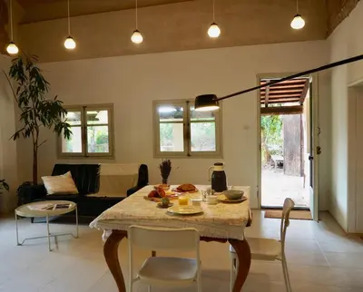 a living room with a table and chairs and a couch at Accommodation in a 13th century Catalan farmhouse in Terrassa