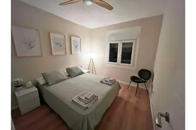 a bedroom with a large bed and a window at Sunny & remodeled Apartment in Sant Boi del Llobregat