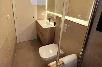 a small bathroom with a toilet and a sink at Sunny & remodeled Apartment in Sant Boi del Llobregat