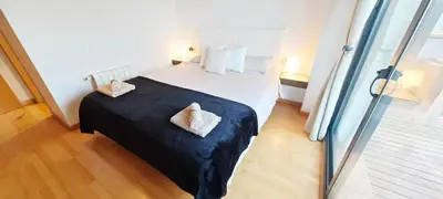 a bedroom with a bed with two pillows on it at Great apartment with a pool on the beach in Barcelona in Badalona