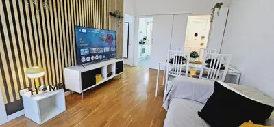 a living room with a couch and a flat screen tv at Premium refurbished apartment in Barcelona city center in Barcelona