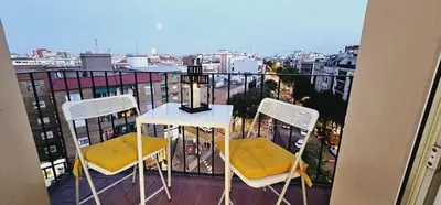 a table and chairs on a balcony with a view of a city at Premium refurbished apartment in Barcelona city center in Barcelona
