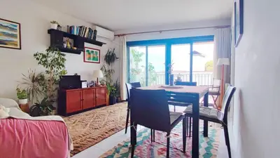 a dining room with a table and chairs in a room at Cosy flat in pretty seaside town in Sitges