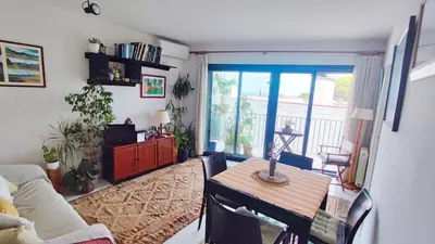 a living room with a table and a couch at Cosy flat in pretty seaside town in Sitges