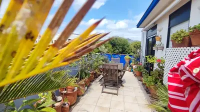 a balcony with chairs and potted plants at Cosy flat in pretty seaside town in Sitges