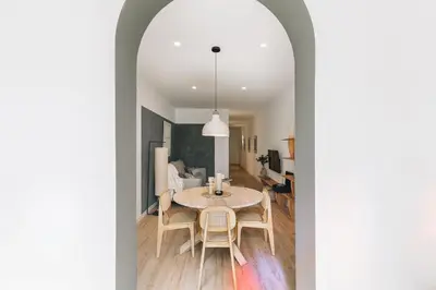 a dining room with a table and a bedroom at Faro - 2 bedroom in Eixample Esquerra in Barcelona