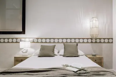 a bedroom with a large bed with two lamps at Faro - 2 bedroom in Eixample Esquerra in Barcelona
