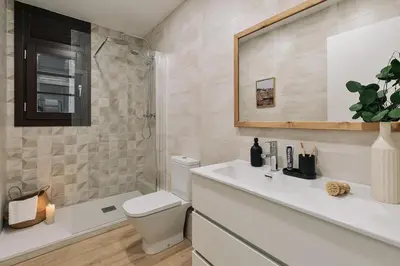 a bathroom with a toilet and a sink and a shower at Faro - 2 bedroom in Eixample Esquerra in Barcelona