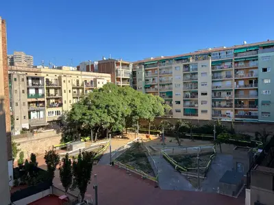 a view of a park in a city with buildings at Click&Flat Gran Via Barcelona in Barcelona