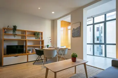 a living room with a table and a dining room at Click&Flat Gran Via Barcelona in Barcelona