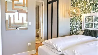 a bedroom with a white bed and a mirror at Gatsby - 3BR Luxury high floor Terrace by Lilla in Barcelona