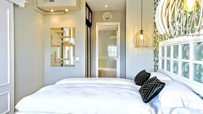 a bedroom with a white bed and a chandelier at Gatsby - 3BR Luxury high floor Terrace by Lilla in Barcelona