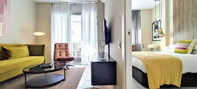 a hotel room with a bed and a couch at Relaxing 3BR w terrace in heart of Gràcia - Bossa in Barcelona