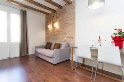 a living room with a couch and a table at Apartments Barcelona Sagrada in Barcelona