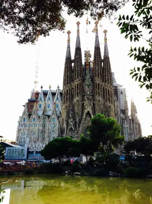 a large building with spires next to a body of water at Apartments Barcelona Sagrada in Barcelona