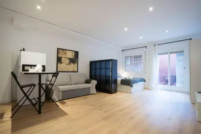 a living room with a couch and a bed at Bcn - Loft Parc Guell in Barcelona