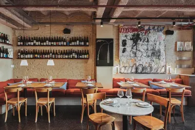 a restaurant with tables and chairs and a red couch at Hotel Casa Bonay & Spa in Barcelona