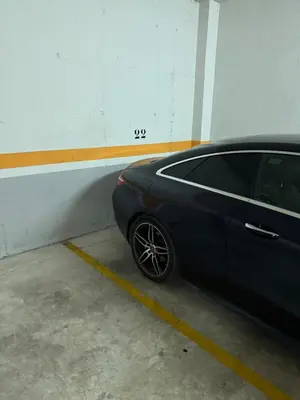 a black car parked in a parking garage at Atico espectacular Cunit in Cunit
