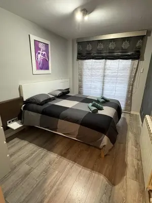 a bedroom with a large bed with a window at Atico espectacular Cunit in Cunit