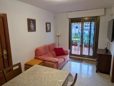 a living room with a couch and a table at Apartamento Barcelona in Hospitalet de Llobregat