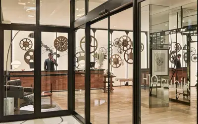 a store with glass windows and a man taking a picture at H10 Cubik 4* Sup in Barcelona