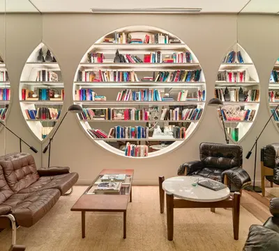 a room with three circular shelves of books at H10 Cubik 4* Sup in Barcelona