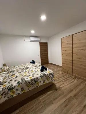 a bedroom with a bed with a floral comforter at Modern apartment 2 Barcelona in Santa Coloma de Gramanet