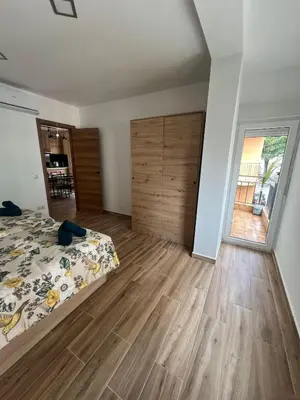 a bedroom with a bed and a large sliding door at Modern apartment 2 Barcelona in Santa Coloma de Gramanet
