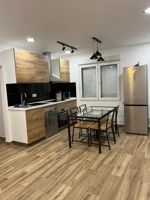 a kitchen with a glass table and a dining room at Modern apartment 2 Barcelona in Santa Coloma de Gramanet